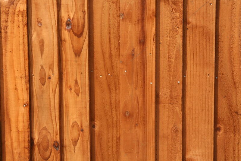 Close-up of stained timber fence palings showing grain and fixings — fencing in Selwyn District