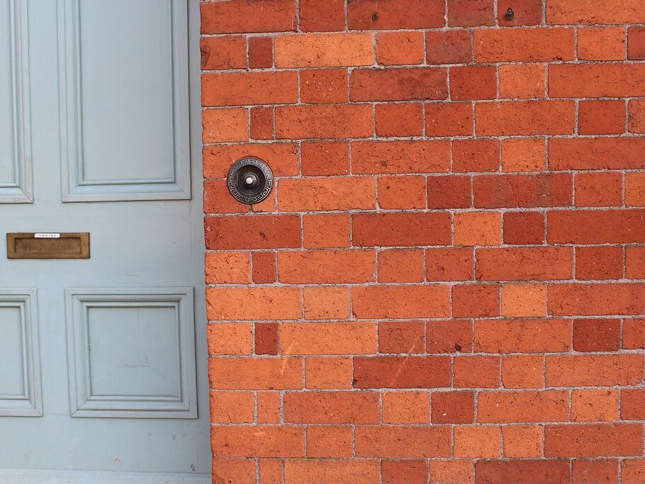 Red brick house wall with front door — brickwork and blockwork in Selwyn District