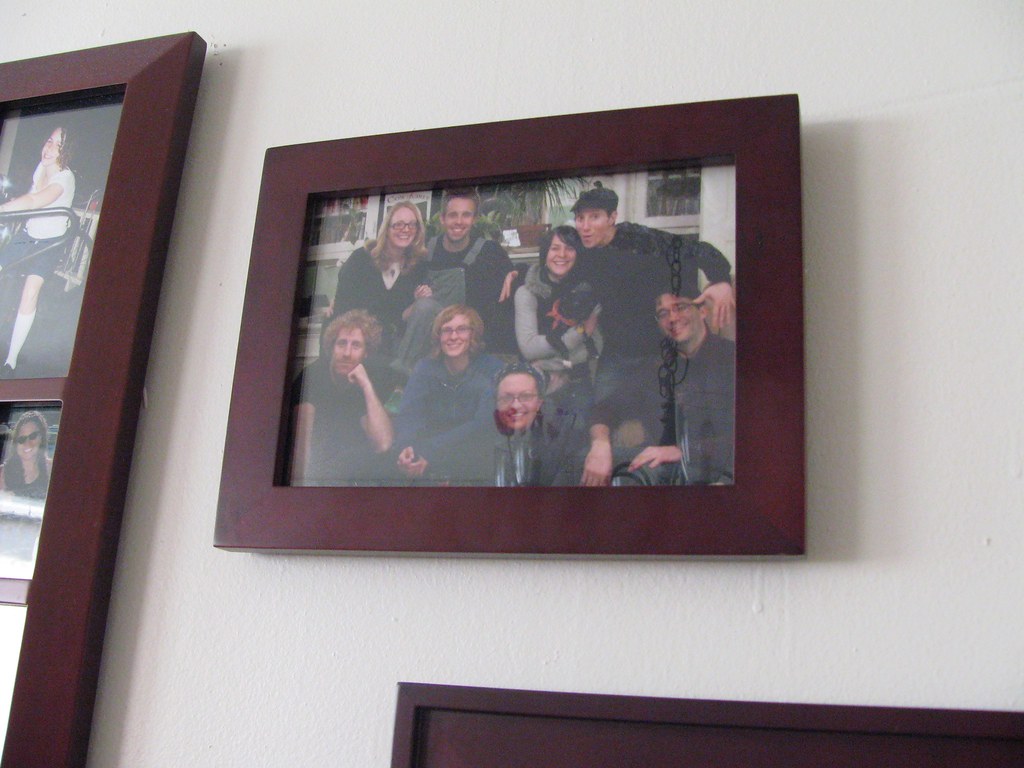 Framed family photographs hung straight on a living-room wall — picture hanging in Selwyn